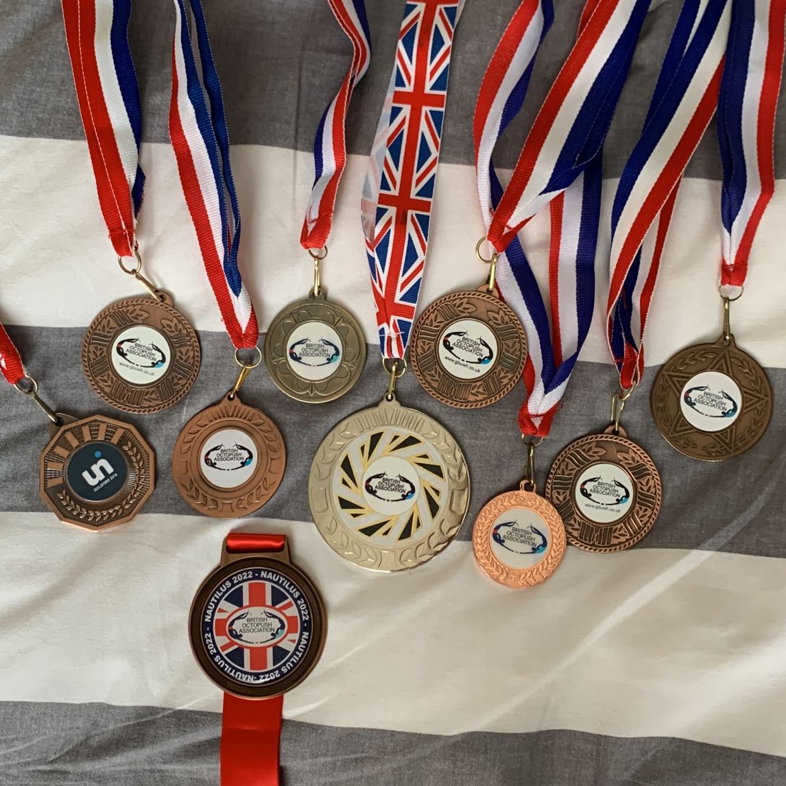 Junior player proudly displaying competition medals